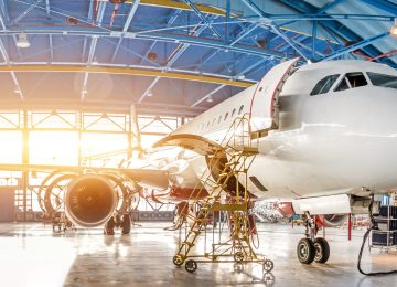 Maintenance and repair of aircraft in the aviation hangar of the airport, view of a wide panorama